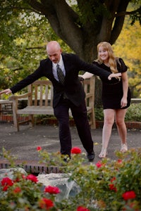 a man in a black suit and a woman in a black dress