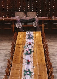 a long wooden table is set up in a barn