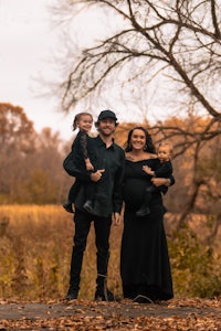 a family posing for a photo in the fall