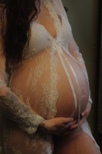 a pregnant woman in a white robe